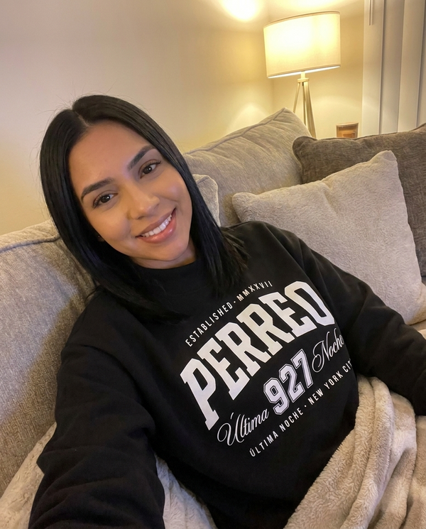 Customer in Perreo sweatshirt on couch